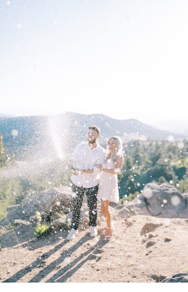 Spraying champagne at colorado engagement session